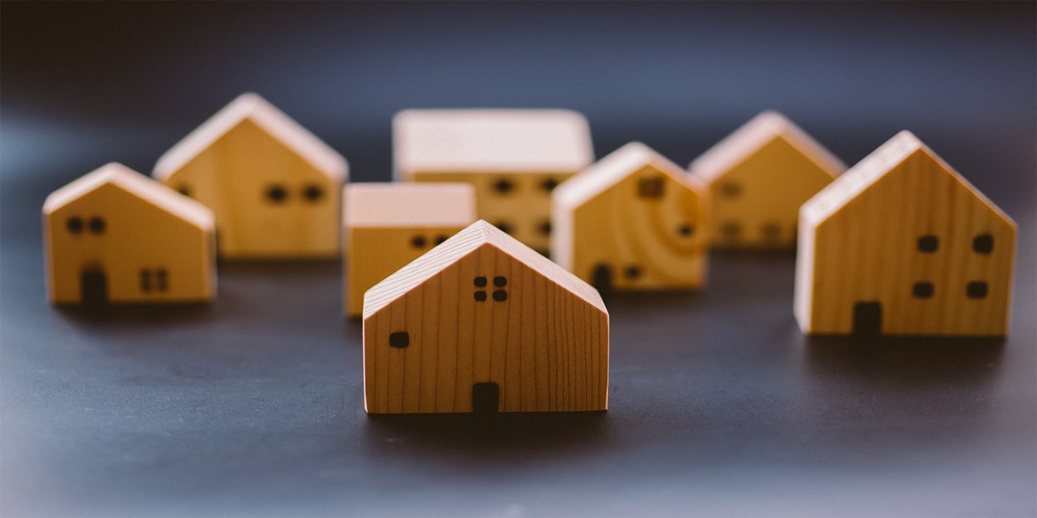 Set of wooden houses to represent landlord rental property ownership